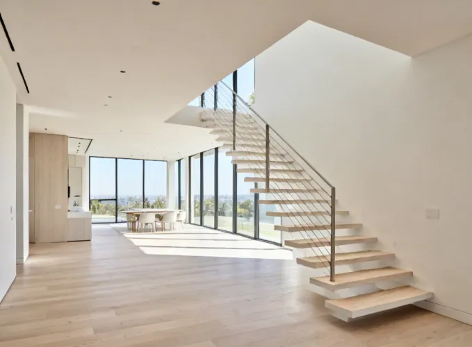 Residential floating staircase with cable railing